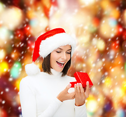 Image showing surprised woman in santa helper hat with gift box