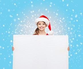 Image showing woman in santa helper hat with blank white board