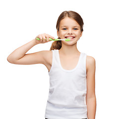 Image showing girl in blank white shirt brushing her teeth
