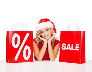 Image showing woman in red dress with shopping bags