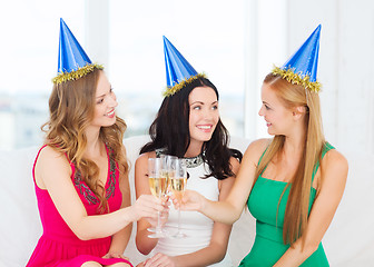 Image showing three women wearing hats with champagne glasses