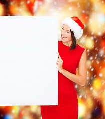 Image showing woman in santa helper hat with blank white board