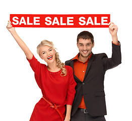 Image showing woman and man with red sale sign