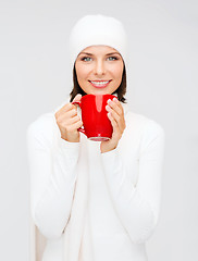 Image showing woman in hat with red tea or coffee mug