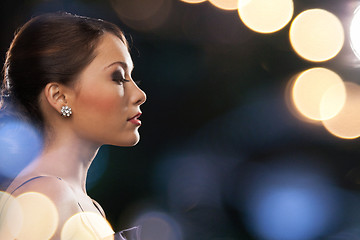 Image showing woman in evening dress wearing diamond earrings