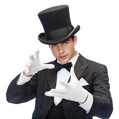 Image showing magician in top hat showing trick