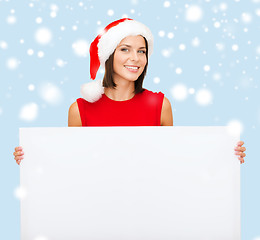 Image showing woman in santa helper hat with blank white board