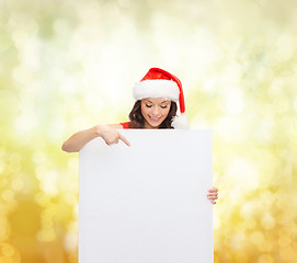 Image showing woman in santa helper hat with blank white board