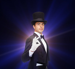 Image showing magician in top hat showing trick