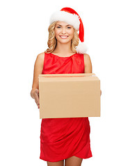 Image showing smiling woman in santa helper hat with parcel box