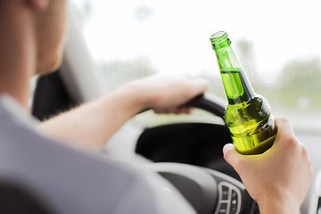 Image showing man drinking alcohol while driving the car