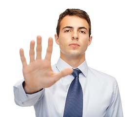 Image showing attractive buisnessman making stop gesture