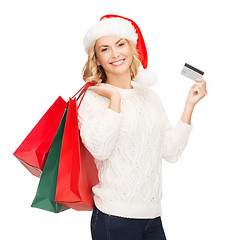 Image showing woman with shopping bags and credit card