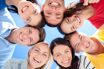 Image showing group of teenagers looking down