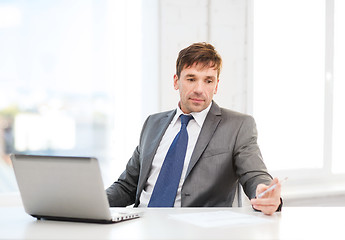 Image showing businessman with laptop computer and documents