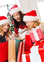 Image showing women in santa helper hats with shopping bags