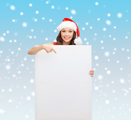 Image showing woman in santa helper hat with blank white board