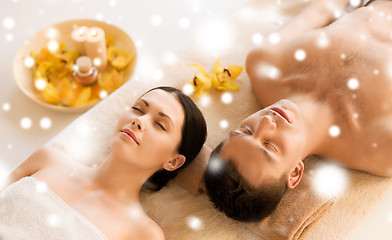 Image showing couple in spa salon lying on the massage desks