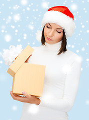 Image showing suspicious woman in santa helper hat with gift box