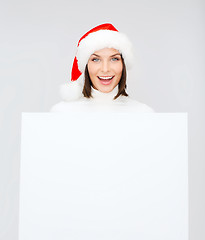 Image showing woman in santa helper hat with blank white board