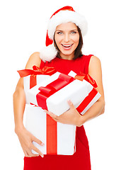 Image showing woman in santa helper hat with many gift boxes