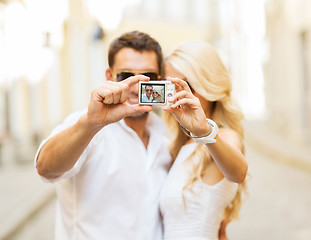 Image showing travelling couple taking photo picture with camera