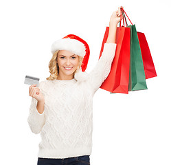 Image showing woman with shopping bags and credit card