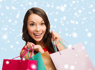 Image showing woman in red dress with shopping bags