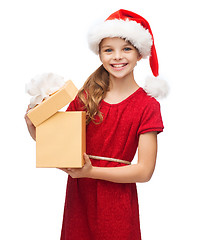 Image showing smiling girl in santa helper hat with gift box