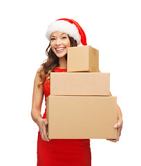 Image showing smiling woman in santa helper hat with parcels