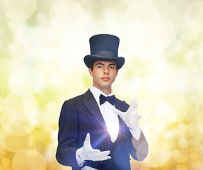 Image showing magician in top hat showing trick