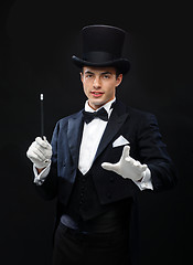 Image showing magician in top hat with magic wand showing trick