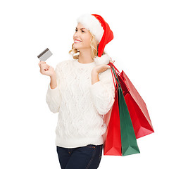 Image showing woman with shopping bags and credit card