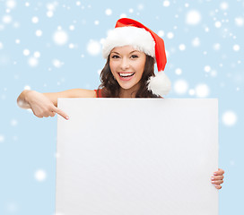 Image showing woman in santa helper hat with blank white board