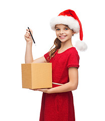 Image showing smiling girl in santa helper hat with gift box