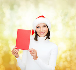 Image showing woman in santa helper hat with blank red card