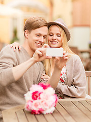 Image showing couple taking picture with smartphone