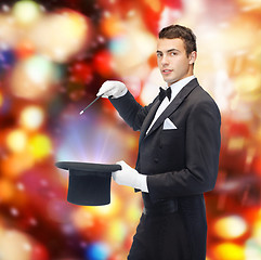 Image showing magician in top hat with magic wand showing trick