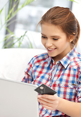 Image showing happy teenage girl with laptop and credit card