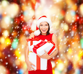 Image showing woman in santa helper hat with many gift boxes