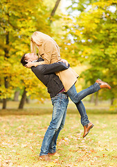 Image showing romantic couple playing in the autumn park