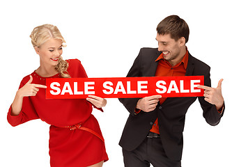 Image showing woman and man with red sale sign