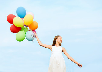 Image showing happy girl with colorful balloons