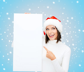 Image showing woman in santa helper hat with blank white board