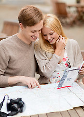 Image showing couple with map, camera and travellers guide