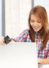 Image showing happy teenage girl with laptop and credit card