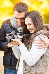 Image showing couple with photo camera in autumn park