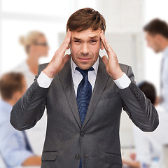 Image showing stressed buisnessman or teacher having headache