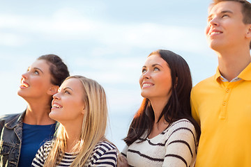 Image showing group of friends looking up on the beach