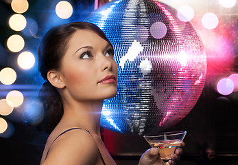 Image showing woman with cocktail and disco ball